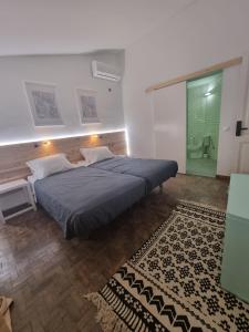 a bedroom with a large bed and a bathroom at Wonder Charm in Albufeira