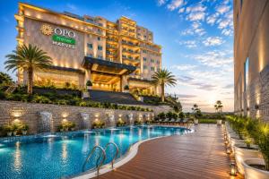 a hotel with a swimming pool in front of a building at OPO Premier Marvel in Jaipur