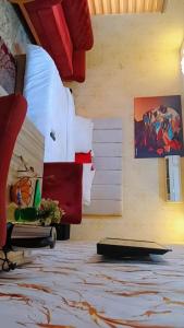 a room with a bed with paintings on the wall at Zamin Suites in Abuja +44 photos