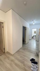 an empty room with white walls and shoes on the floor at Daraboz in Almaty