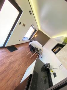 an attic kitchen with a large window and wood floors at Cabaña San Pedro 2 in Concepción