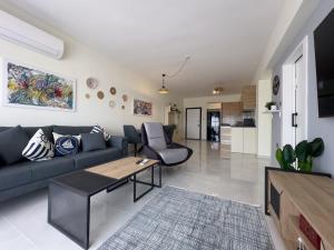 a living room with a couch and a table at Luxury 2 Bedroom Apartment in Caesar Resort in Iskele