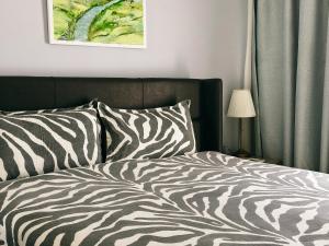 a bed with a zebra printed comforter in a bedroom at Luxury 2 Bedroom Apartment in Caesar Resort in Iskele +31 photos