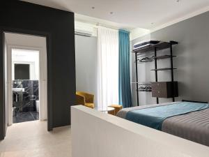 a bedroom with a bed and a room with a desk at Suite Apollinare in Ravenna