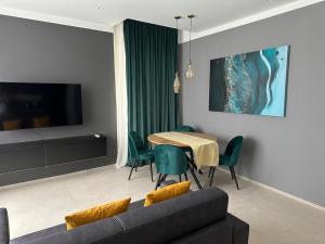 a living room with a couch and a table with chairs at Suite Apollinare in Ravenna +11 photos