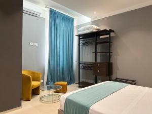 a bedroom with a bed and a blue curtain at Suite Apollinare in Ravenna