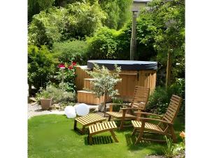 a garden with three chairs and a gazebo at Gîte Escapade À La Voreille in Mazirat