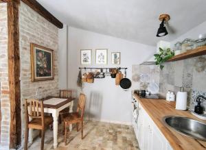 a kitchen with a table and a sink and a counter at Casa Horea 54 in Cluj-Napoca