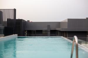 a swimming pool on the side of a building at Nova, Sky Suites in Accra