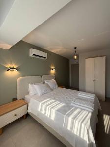a bedroom with a large white bed in it at Fethiye Serenity Suites in Fethiye
