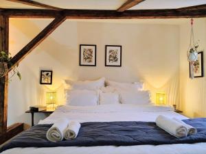 a bedroom with a large bed with towels on it at Casa Horea 54 in Cluj-Napoca