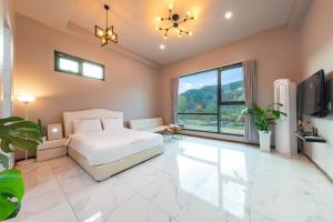 a bedroom with a bed and a large window at Namiseom 2020 Spa Poolvilla in Chuncheon