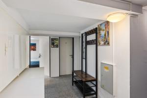 a hallway with white walls and a stair case at MK Rooms Bremen in Bremen
