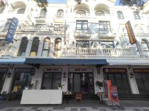 a white building with a balcony on top of it at SOLÉRA 2 Homestay in Phú Quốc