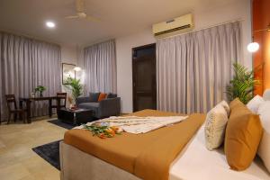 a bedroom with a bed and a living room at Studio Serviced Apartments near Fortis Hospital in Gurgaon