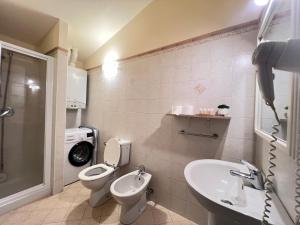 a bathroom with a toilet and a sink and a shower at Dimora le tagliate in Lucca +31 photos