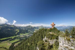 a cross on the top of a mountain at Hotel Tiroler Adler - bed and breakfast in Waidring