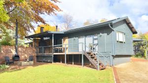 a tiny house with a porch and a deck at Fine Stay Clarens in Clarens