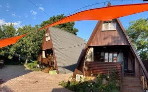 a small house with a large orange tent at Дача Фонтанка in Fontanka