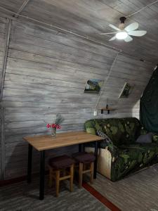 a living room with a table and a couch at Дача Фонтанка in Fontanka +49 photos