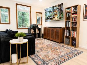 a living room with a couch and a tv at Boho Burrow in Monte Rio