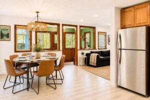 a kitchen and dining room with a table and a refrigerator at Boho Burrow in Monte Rio