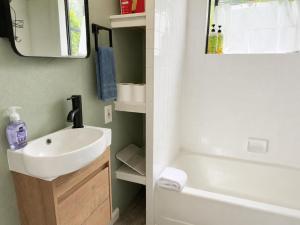 a bathroom with a sink and a toilet and a tub at Boho Burrow in Monte Rio +17 photos