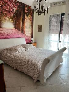 a bedroom with a bed with a tree mural at CASA NINETTA in Bari