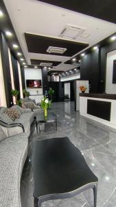 a lobby with couches and a table in a room at Апарт-отель Homeland in Gonio
