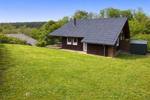 a small house with a grassy yard in front of it at Extertal-Ferienpark - Sonnenhügel in Extertal