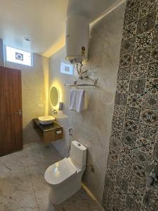 a bathroom with a toilet and a sink at Hotel LimeStarow in Bijni +19 photos