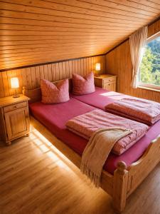 a bedroom with a large bed in a wooden room at Extertal Ferienpark Sauna Wald 51 in Extertal