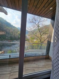 a large window with a view of a mountain at Hotel LimeStarow in Bijni