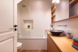 a bathroom with a sink and a toilet and a tub at LETS HOLIDAYS NICE HOUSE CLOSE to the CASTLE in Tossa de Mar +30 photos