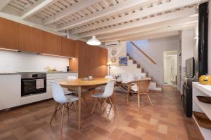 a kitchen and dining room with a table and chairs at LETS HOLIDAYS NICE HOUSE CLOSE to the CASTLE in Tossa de Mar