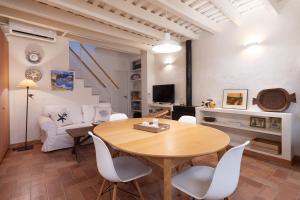 a living room with a wooden table and white chairs at LETS HOLIDAYS NICE HOUSE CLOSE to the CASTLE in Tossa de Mar