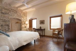 a bedroom with a bed and a table and chairs at LETS HOLIDAYS NICE HOUSE CLOSE to the CASTLE in Tossa de Mar