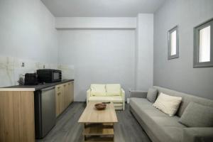 a living room with a couch and a coffee table at Sea Breeze Stay 1 in Salamina