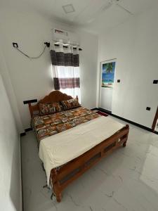 a bedroom with a large bed in a room at Ocean Heart Guest House in Nilaveli