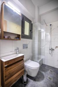a bathroom with a toilet and a sink and a shower at Sea Breeze Stay 1 in Salamina +25 photos