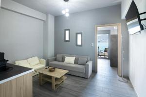 a living room with a couch and a table at Sea Breeze Stay 1 in Salamina