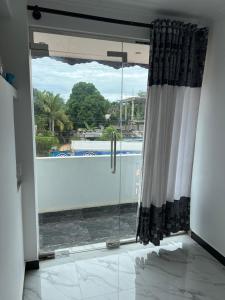 a room with a window with a view of a pool at Ocean Heart Guest House in Nilaveli