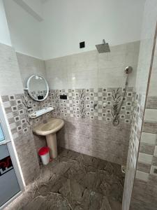 a bathroom with a sink and a mirror at Ocean Heart Guest House in Nilaveli
