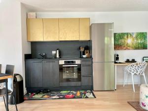 a kitchen with a stove and a refrigerator at Appartement Zirbe in Rickenbach +16 photos