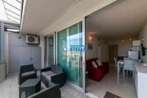 a living room with a red couch and a table at Condominio Mimose in Eraclea Mare