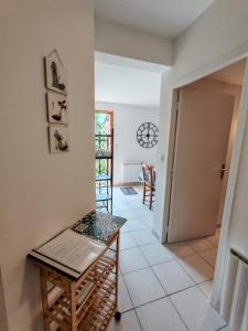 a hallway with a table and chairs in a house at gite villa ardeche joyeuse piscine in Joyeuse