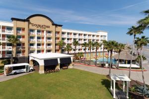 an aerial view of a resort with a large building at DoubleTree by Hilton Galveston Beach in Galveston