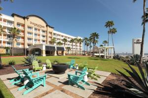 a hotel with a bunch of chairs in front of it at DoubleTree by Hilton Galveston Beach in Galveston +65 photos