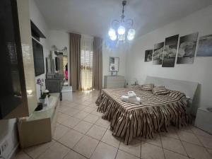 a bedroom with a bed with a blanket on it at Sicily Summer in Nunziata