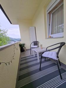 a balcony with two chairs and a table and a window at Una Vibe Studio in Bosanska Krupa